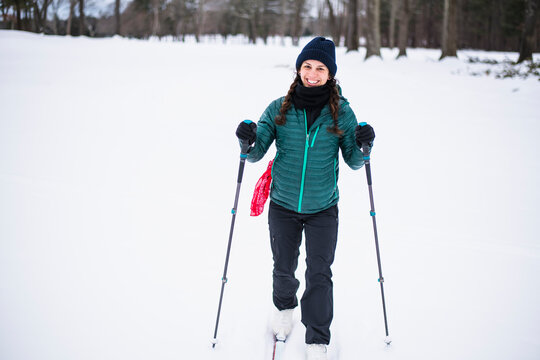 Woman happily cross country skiing in winter