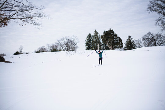 Woman happily cross country skiing in winter