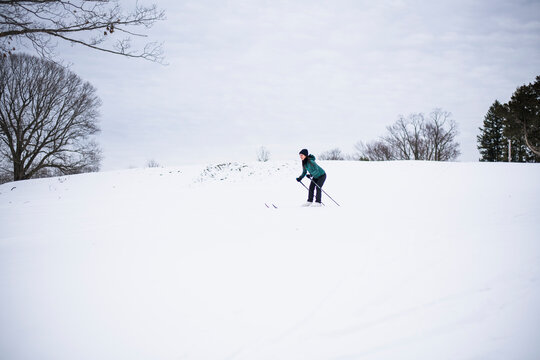 Woman happily cross country skiing in winter
