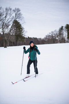 Woman happily cross country skiing in winter