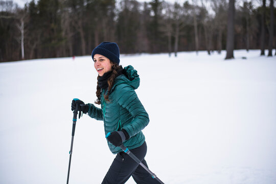 Woman happily cross country skiing in winter