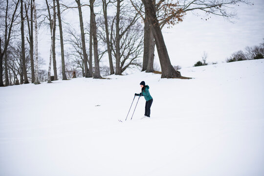 Woman happily cross country skiing in winter