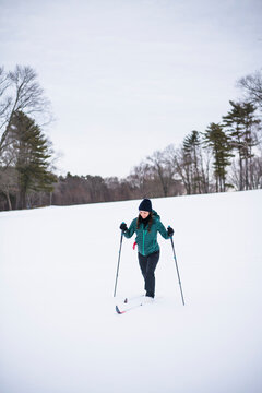 Woman happily cross country skiing in winter