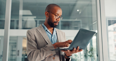 Online, research and businessman with laptop, office and financial analysis on web, typing and info. Investment banker, black person and plan for pitch with technology, wealth management or low angle