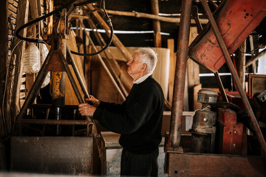 Elderly man working in an old workshop