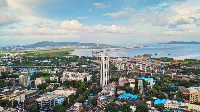 A beautiful aerial view of the high-rise skyscrapers of Mumbai city in Maharashtra during monsoon. India's Longest Sea Bridge 'Trans-Harbour Sea Link. Nhava Sheva-Sewri sea bridge in Mumbai, India.