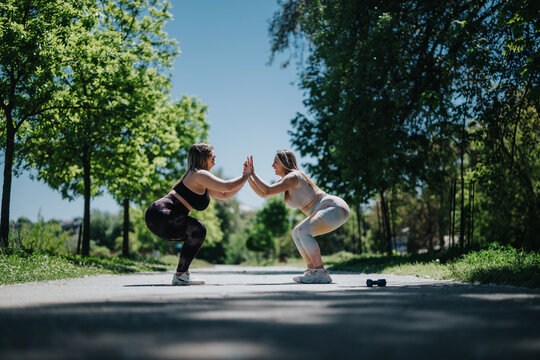Women exercising, symbolizing teamwork and health in a serene and natural park environment, encouraging healthy lifestyle choices and mutual motivation during a fitness session under sunny skies. - Powered by Adobe