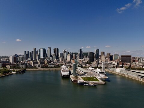 Aerial view of the Old Port, with its iconic clock tower and cruise ships, against a backdrop of modern skyscrapers, Montreal, Quebec, Canada.