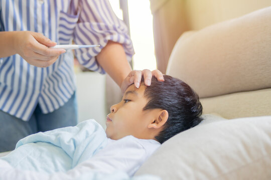 Mom, sick boy and tool for fever in home, virus and monitor temperature for covid infection.