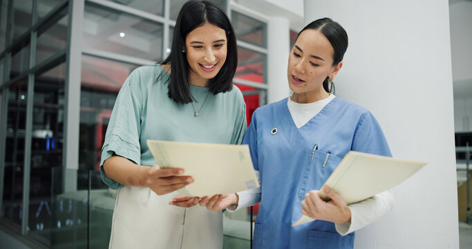 Reading, documents and nurse with women in hospital for ward clerk, icu emergency and medical records at night. Healthcare administration, surgery schedule and low angle with people for overtime