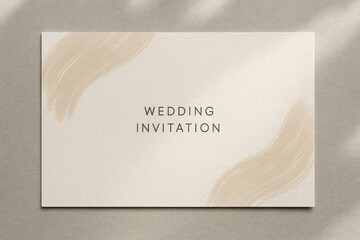 Elegant wedding invitation card with beige abstract brush strokes on textured paper. Minimalist design perfect for romantic event stationery.