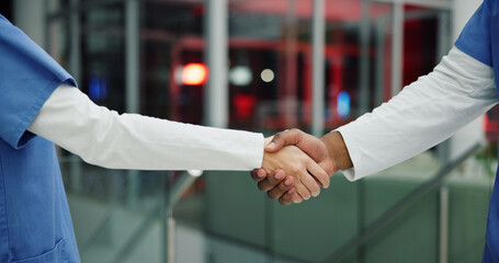 Medical, night or people in hospital with handshake, thank you or support in end of surgery. Bokeh, medicine community or nurse in clinic with hands together, well done and overtime in post operation