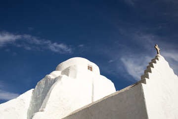 traditional white greek chapel on deep blue clear sky backdrop. religious building. greek islands architecture. minimalist conceptual architectural wallpaper with