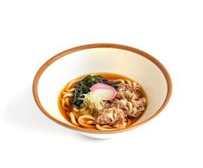 A steaming bowl of Japanese niku udon with tender sliced beef and thick udon noodles in rich broth, presented on a clean table for menu or editorial use.