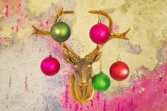 Golden deer head with Christmas baubles on vintage shabby chic wall