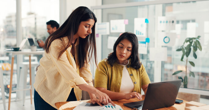 Laptop, meeting and business women with documents for research, finance report or profit growth. Office, team and people on computer with paperwork, graph and chart for budget, analysis or statistics