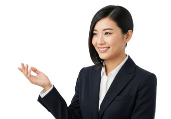 Smiling young asian businesswoman in a dark suit gesturing with her left hand isolated on transparent background