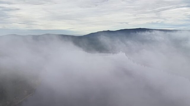 Valley shrouded by thick fog layers observed, Research drone records humidity and ridge details for climate analysis