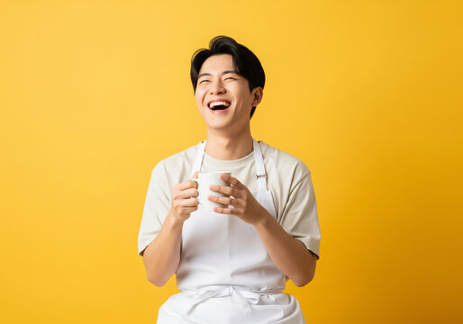 Smiling barista holding a coffee mug on yellow background