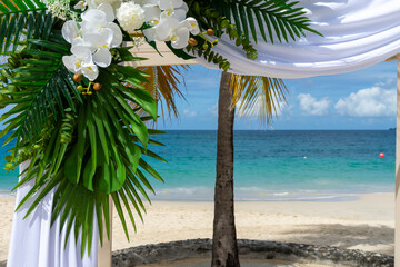 Delicate white orchids, lush tropical foliage and silk drapes create a timeless setting for island vows