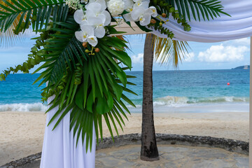 White orchids and silk drapes adorn a Caribbean wedding pagoda in a scene of pure tropical elegance