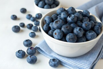 Fresh Blueberries in a White Bowl on a Striped Cloth