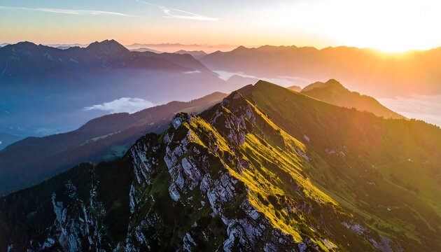Sunrise crests jagged mountain peaks; fog fills valleys beneath, bathed in golden light - Powered by Adobe