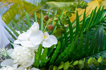 Delicate white orchids, lush tropical foliage and silk drapes create a timeless setting for island vows