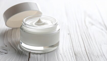 Aesthetic white cream jar with lid on a white wooden surface for skincare