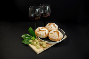 Pumpkins and freshly baked buns on black background