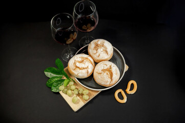 Pumpkins and freshly baked buns on black background
