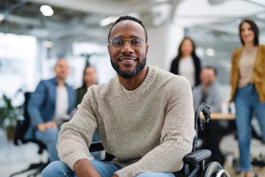 Confident african male professional in wheelchair leading diverse office meeting
