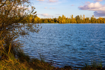 Banks and lawns around Lake Sabatouse in autumn in Longages