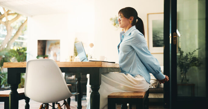 Woman, stretching and back pain with laptop for remote work from home office, fatigue or deadline. Mature person, freelance writer and tired with injury, bad posture or computer for project in house