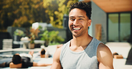 Portrait, trainer or happy man with outdoor yoga class at resort, health or body wellness practice. Join us, pilates session or confident coach with laugh for fitness, holistic exercise or retreat