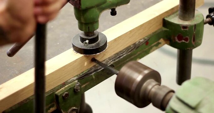 carpenter repairs making antique furniture using a drill machine Carpentry, craftsmanship, Handicrafts workshop activity - Powered by Adobe