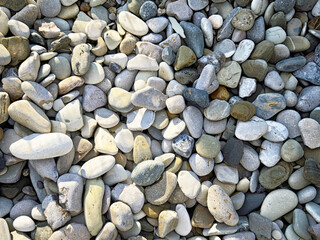 Colorful pebbles and stones create a natural texture perfect for backgrounds and design elements
