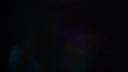 Sun glare, lens flare on a black background for transition to video. Colored rays	 - Powered by Adobe