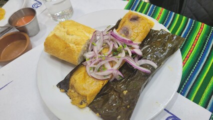 Tamales, a traditional Mesoamerican dish very popular in several Latin American countries, including Mexico and Peru. They consist of corn flour dough filled with various ingredients