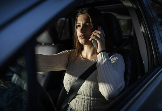 Woman using phone while driving car