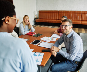 Portrait of a group of young business people having a meeting or training in the office. Teamwork...