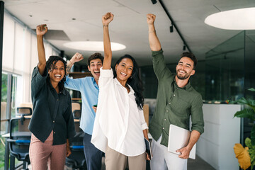 Joyful, excited diverse entrepreneurs are celebrating their success and the great work environment