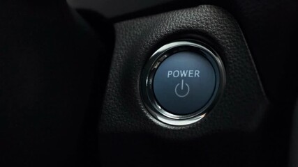 closeup button Ignition of car engine by pushing a button hand concept technology electric vehicles - Powered by Adobe