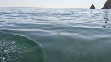Ocean Waves Sea Coastline Water - A close up shot of waves crashing on a beach near a rocky coastline.