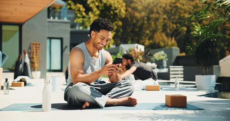 Yoga, smile and phone with man in class for spiritual retreat, social media and communication. Pilates workout app, wellness club and online mindfulness guide with person outdoor for fitness