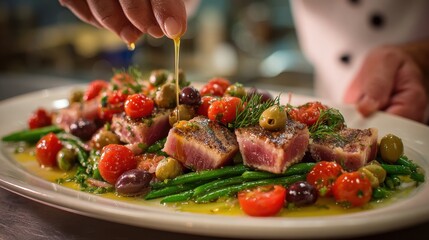 Chef preparing a vibrant and delicious Nicoise salad dish