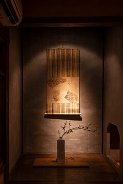 Kakemono - a hanging scroll, decorating a japanese home is dimly light at night