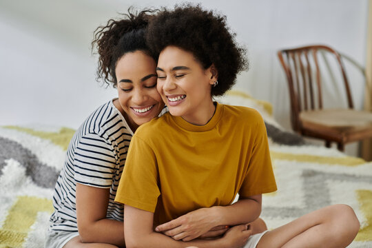 Happy lesbian couple enjoying each other's company in a cozy modern apartment - Powered by Adobe