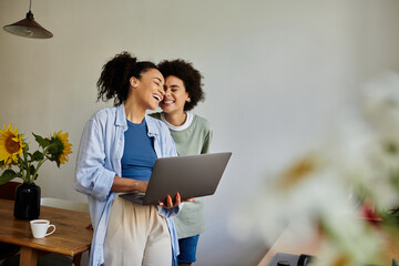 Happy African American women enjoying quality time in their modern apartment together