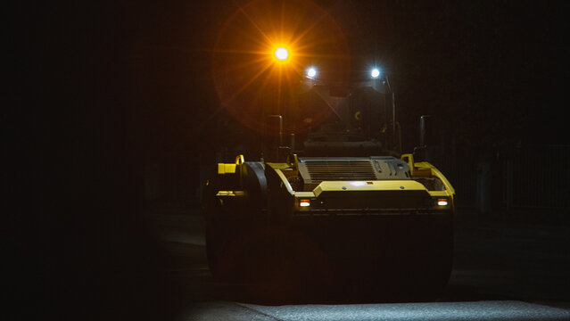 desolate street scene with maintenance vehicle preparing for overnight repairs under moody lighting - Powered by Adobe
